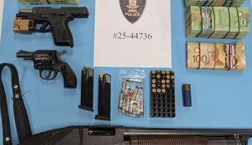 Weapons and cash seized in a raid by Windsor police on May 8, 2025. Photo courtesy Windsor police.