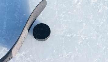 Hockey stick and a puck. © Can Stock Photo / bradcalkins