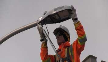 Chris Carr with Enersource Power Services installs an LED street light outside of St. Rose Catholic Elementary School in Windsor on December 9, 2015. (Photo courtesy City of Windsor)