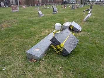 Damaged headstones are shown at St. Alphonsus Roman Catholic Cemetery in Windsor, April 9, 2025. Photo by Mark Brown/WindsorNewsToday.ca.