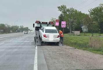A vehicle is towed from the site of a traffic stop on Highway 3 in Tecumseh, May 13, 2025. Photo courtesy OPP West Region/X.