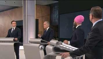 Liberal Party Leader Mark Carney, second from left, speaks while Conservative Leader Pierre Poilievre, from left, NDP Leader Jagmeet Singh, and Bloc Quebecois Leader Yves-Francois Blanchet listen during the English leaders' debate in Montreal, April 17, 2025. Screenshot courtesy CPAC/YouTube.